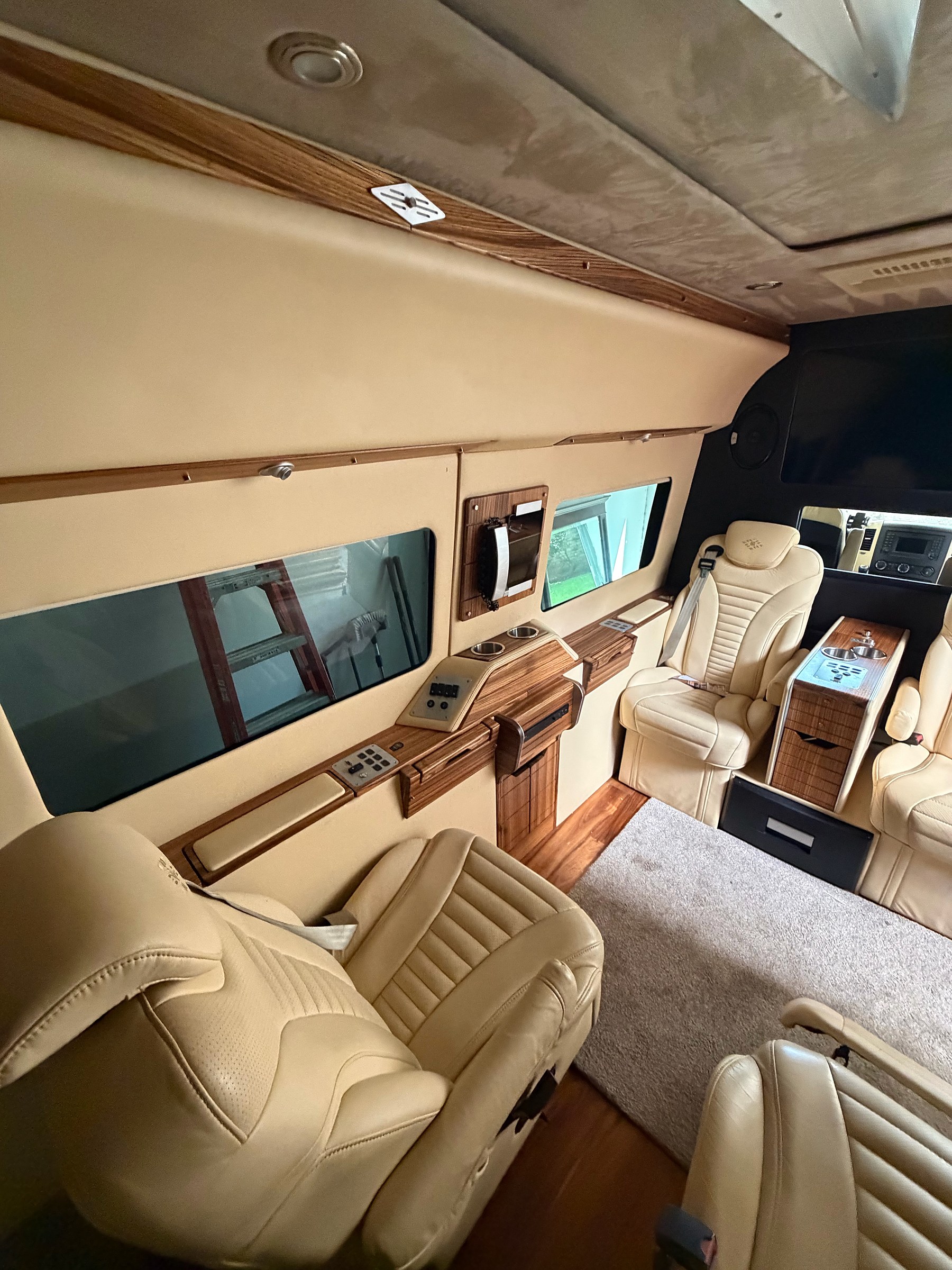 Leather captain chairs and suede ceiling